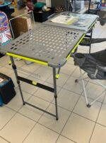 Maksimali apkrova — 200 lb / 90,7 kg. Stalas skirtas lauko virtuvei: viena pusė naudojama maisto ruošimui, kita — nešiojamai viryklei ar griliui. Turi „FlexRail“ aksesuarų sistemą: puodelių laikiklius, kabliukus įrankiams, šiukšlių maišo laikiklį, popierinių rankšluosčių laikiklį. Aukštis reguliuojamas 4 pozicijomis viena ranka. Konstrukcija iš milteliniu būdu dengto plieno ir UV atsparaus stalviršio. Sulankstytas tampa gana plonas, todėl patogu vežtis automobilyje. ~157 cm ilgio. Stalo svoris apie 15 kg.