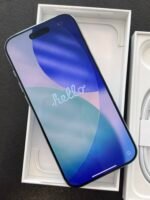 New smartphone in white packaging, screen shows blue gradient wallpaper with the word 'hello'.