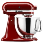Red KitchenAid Artisan stand mixer with a shiny stainless steel mixing bowl and tilt-head design.
