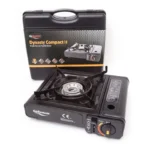 Portable single-burner camping stove (GoSystem Dynasty Compact II) with its black carrying case in the background.