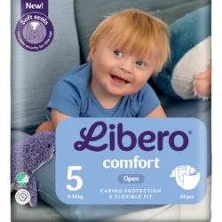 Baby smiling in a blue onesie on top of a Libero Comfort diaper package (size 5, 34 pcs) showing 'caring protection & flexible fit' label with a purple 'New! Soft seals' badge in the corner