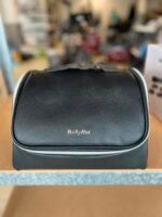 Black textured cosmetic case with a wavy gray clasp on top and a silver BaByliss logo on the front.