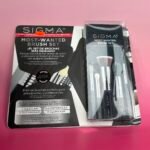 Sigma Most-Wanted Brush Set packaging on a pink surface, with a small red price sticker visible.