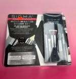 Sigma Most-Wanted Brush Set packaging on a pink surface, with a small red price sticker visible.
