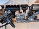 Vacuum cleaner parts in molded packaging: floor brush, wand, hose, and attachments.