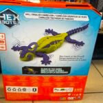 Box for a Hex Bots toy showing a yellow-green chameleon robot with purple limbs; packaging highlights a wall crawler and ground crawl feature.