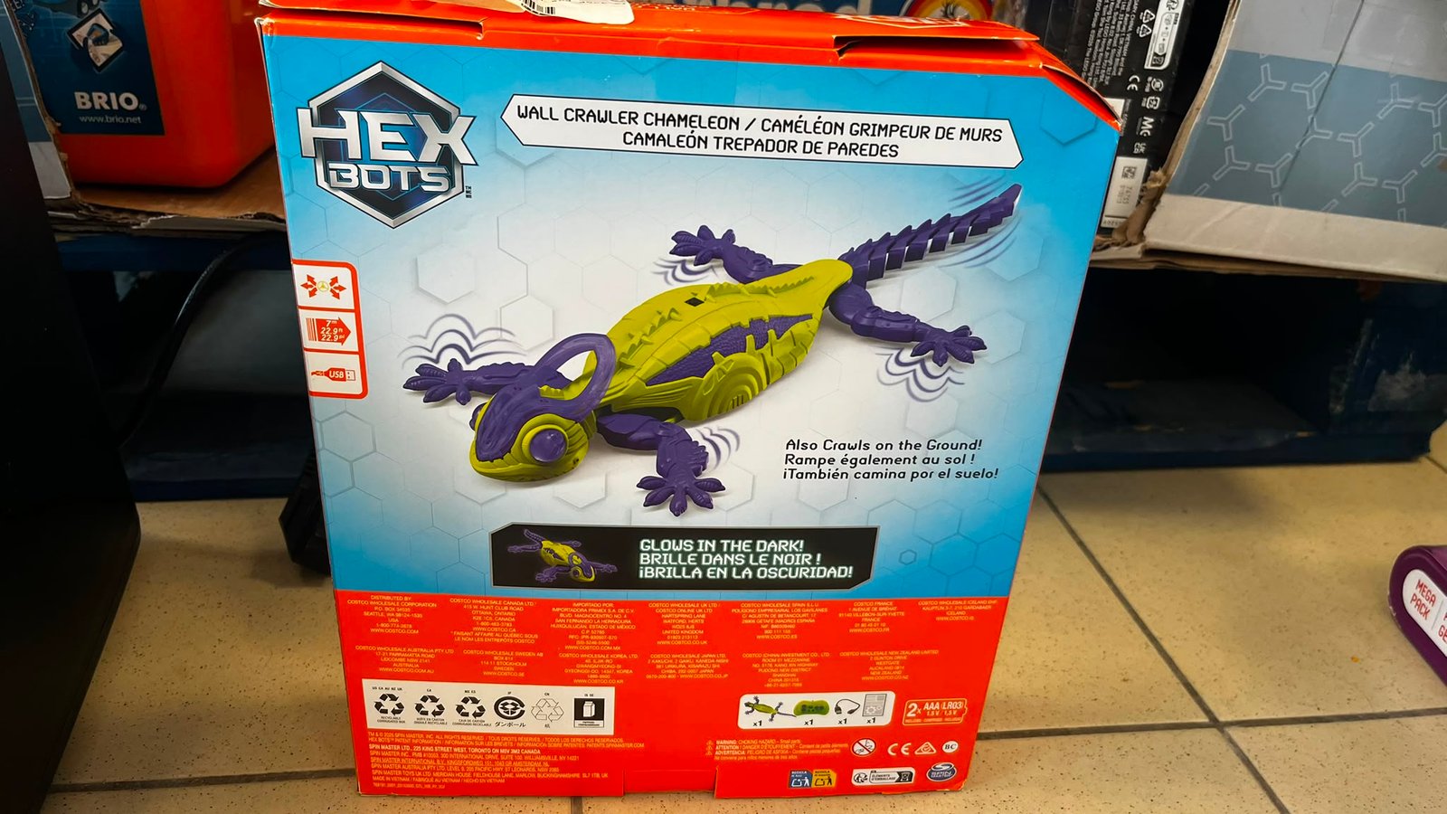 WhatsApp Image 2026-07-31 at 120042 - Radau Viska Box for a Hex Bots toy showing a yellow-green chameleon robot with purple limbs; packaging highlights a wall crawler and ground crawl feature.