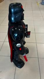 Life-size Darth Vader figure with black armor, cape, and red lightsaber hilt standing on a tiled floor display area.