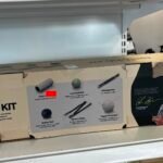 Box labeled 'Centr Recovery Kit' on a store shelf, with illustrations of foam roller, lacrosse ball, and massage bar.