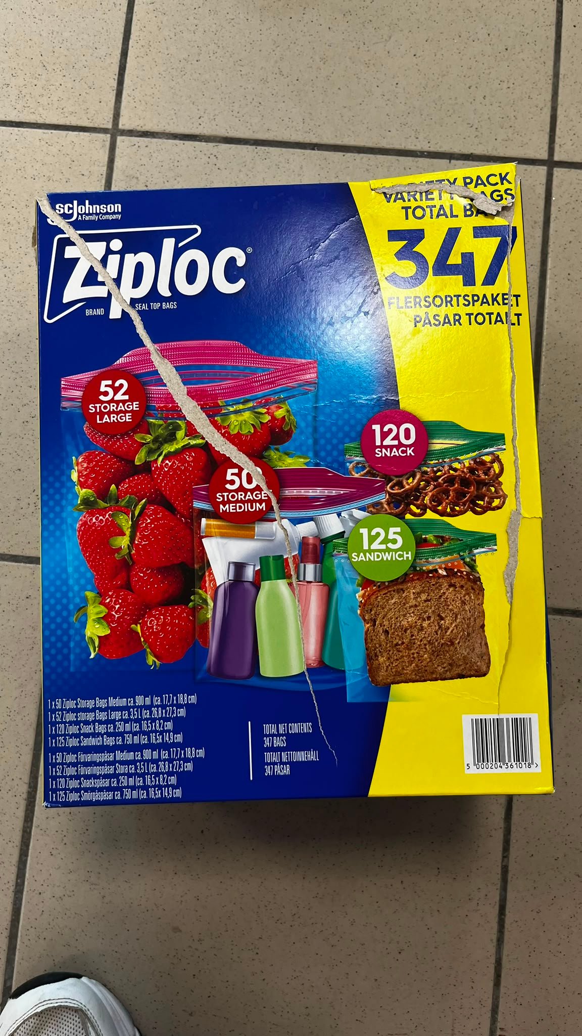 WhatsApp Image 2026-07-31 at 134103 - Radau Viska Blue Ziplock variety pack box with yellow panel showing '347' total bags; torn packaging visible on top edge, fruit and sandwich bags pictured on front, indicating storage bags assortment for home use.