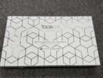 White rectangular packaging with a geometric hex pattern, labeled 'faceLITE Evolution' and 'Beauty Boosting Light Treatment' by the beauty specialists.