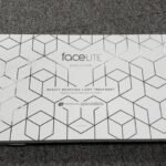 White rectangular packaging with a geometric hex pattern, labeled 'faceLITE Evolution' and 'Beauty Boosting Light Treatment' by the beauty specialists.