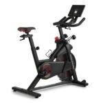 ProForm indoor cycling bike with adjustable seat and aero handlebars, featuring a mounted digital console on the front panel