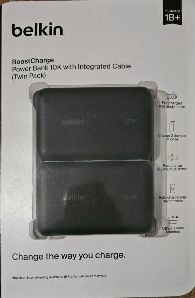 Front of Belkin BoostCharge Twin Pack box showing two black 10K power banks with integrated cable and Belkin branding.