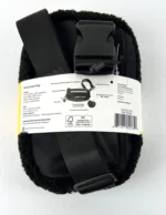 Fleece belt bag with black adjustable strap and plastic buckle, packaging label wrapped around the middle.