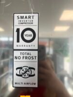 Vertical metal sign listing refrigerator features: Smart Inverter Compressor, 10-year warranty, no frost, multi airflow.