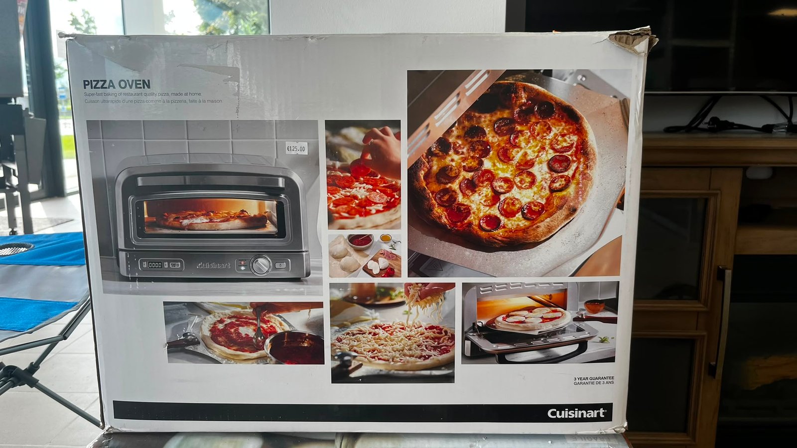 WhatsApp Image 2026-08-01 at 110952 - Radau Viska Box showing a 'Pizza Oven' by Cuisinart with collage of pizzas and an oven image on the front panel, product packaging visible in a showroom.