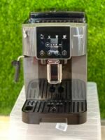 Front view of a De'Longhi Magnifica Start espresso machine with a touchscreen panel and brew options.
