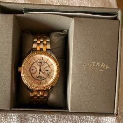 Two-tone gold and silver Rotary wristwatch with a crystal-studded bezel in a gray presentation box