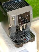 Espresso machine front with control panel, steam wand, and drip tray visible on a kitchen counter